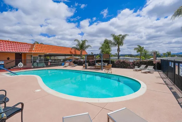 a view of a house with backyard porch and sitting area