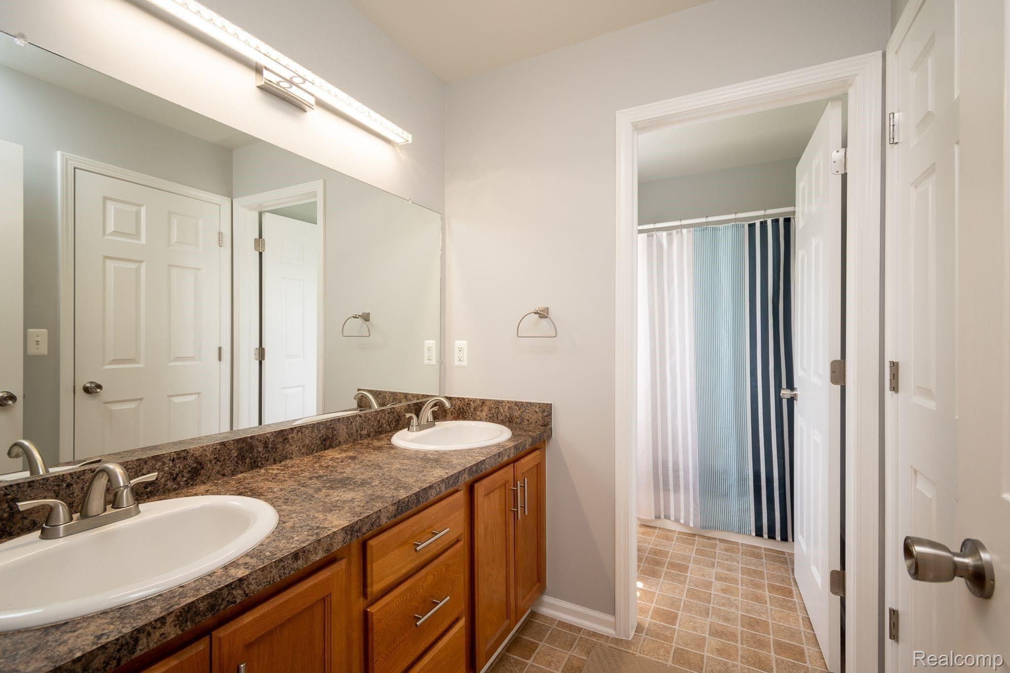 2457 Durham Road Utica, MI 48317 - Photo 14 of 27 12 x 6 Jack and Jill Bathroom between two kids' bedrooms; has a door between dual sinks and shower/toilet