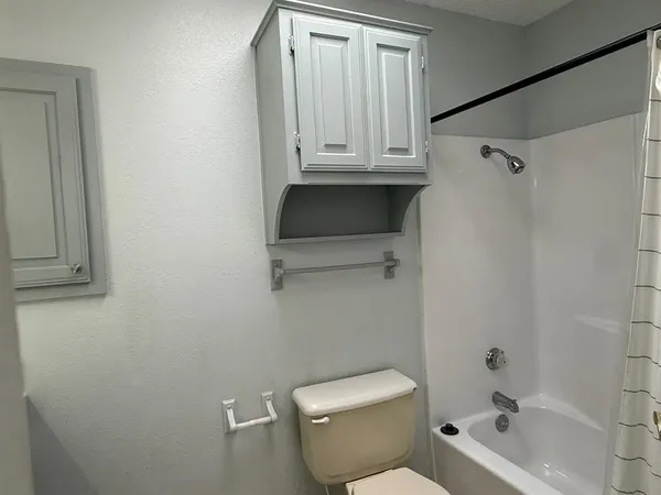 a bathroom with a toilet a sink and bathtub