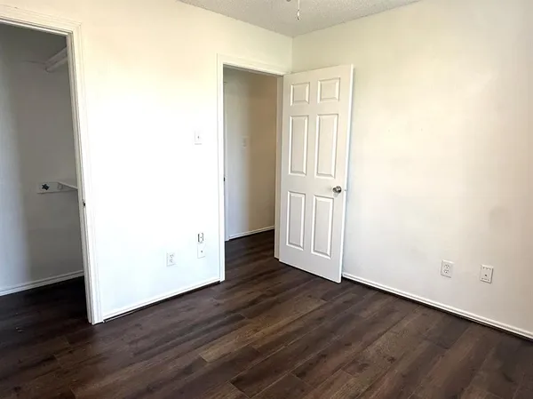 an empty room with wooden floor