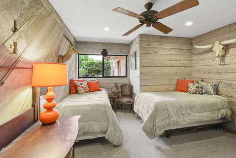 a bedroom with bed and a chandelier