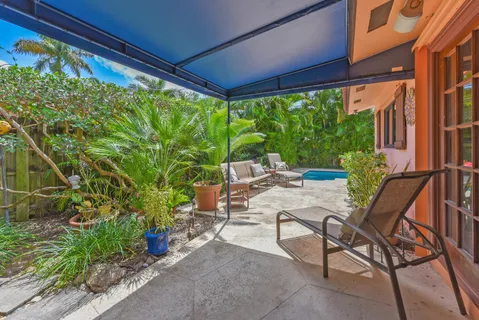a view of a patio with table and chairs and potted plants