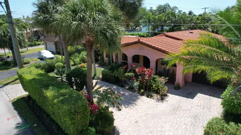 a view of a house with a flower garden