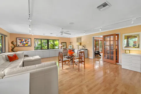 a living room with furniture and a wooden floor