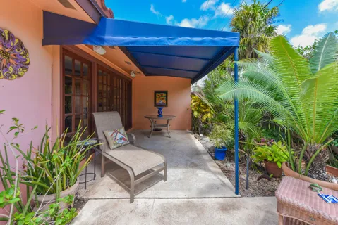 a backyard of a house with outdoor seating