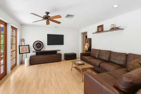 a bedroom with furniture and a ceiling fan