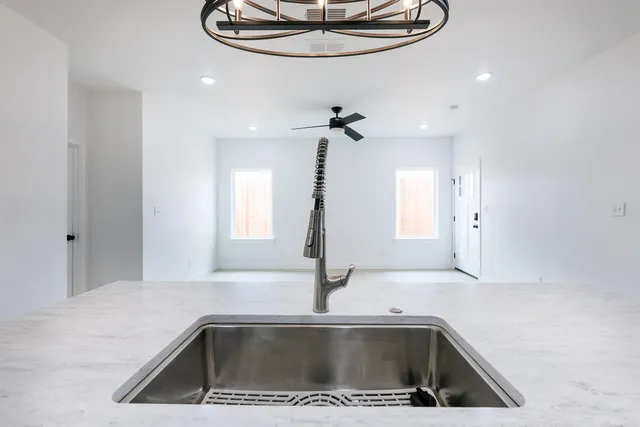 a kitchen with a sink a counter top space and cabinets