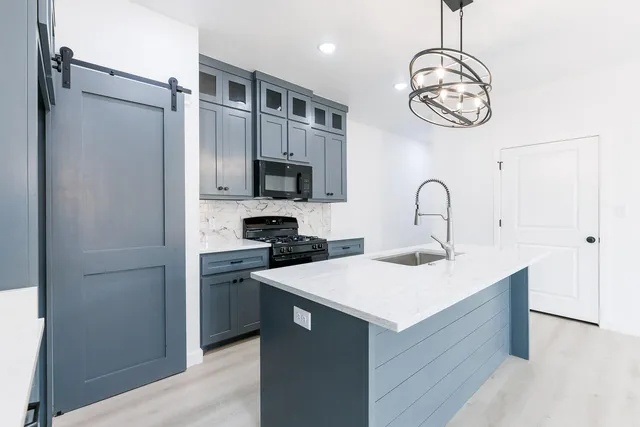 a kitchen with a refrigerator and a sink