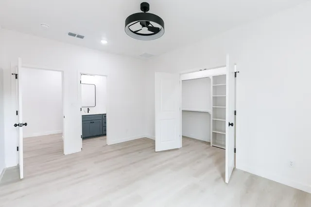 a view of a room with a closet and electronic appliances