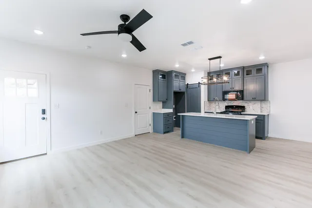 a view of kitchen with sink microwave and stove