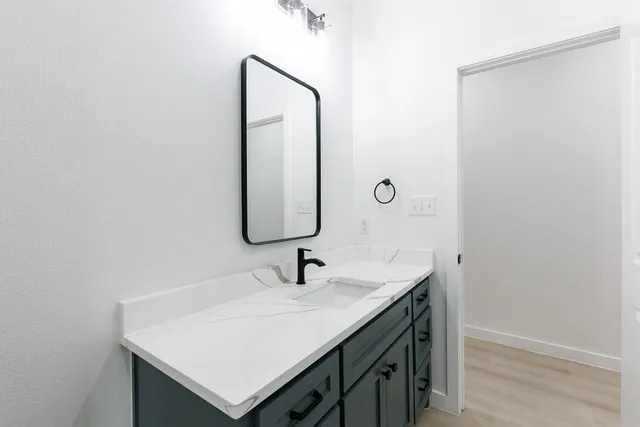 a bathroom with a sink and a mirror