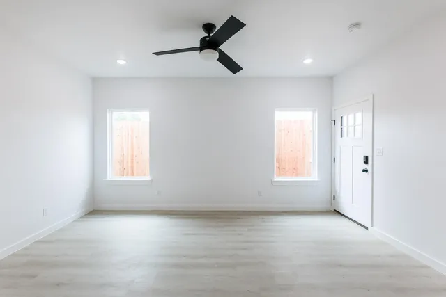 wooden floor in an empty room with a window