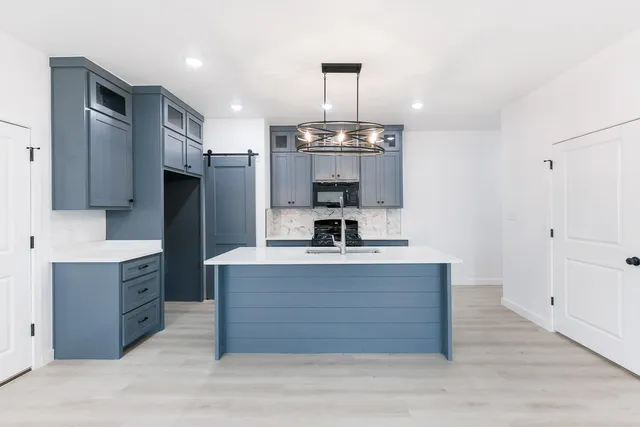 a kitchen with stainless steel appliances a sink stove and refrigerator