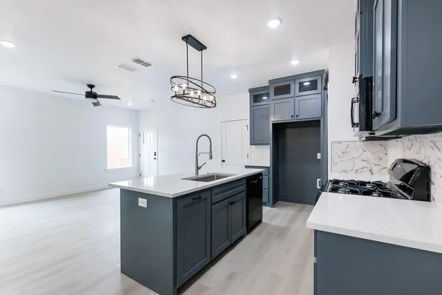 a kitchen with stainless steel appliances a sink stove and refrigerator