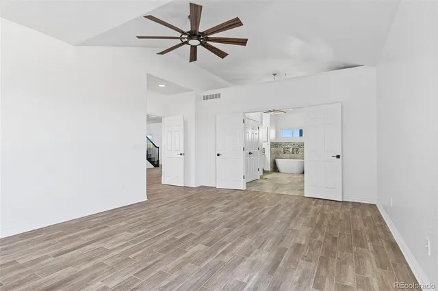 a view of empty room with wooden floor