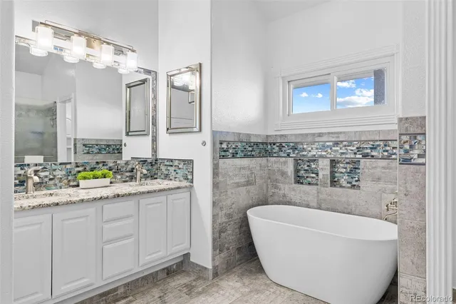 a bathroom with a bathtub a sink and a window