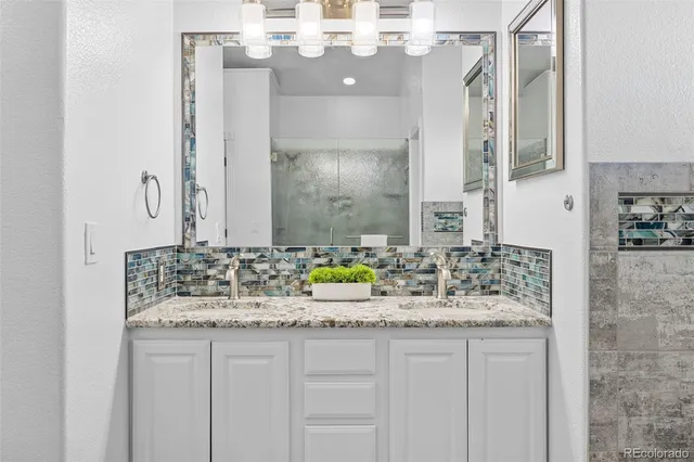 a bathroom with a sink vanity and a mirror