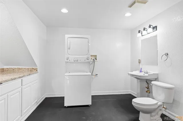 a bathroom with a sink a toilet and mirror