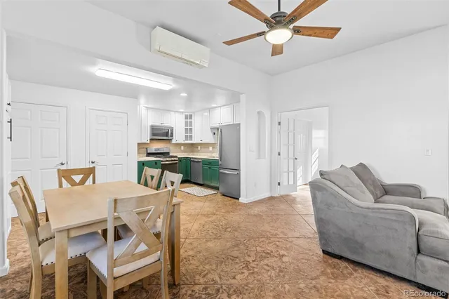 a living room with furniture and kitchen view