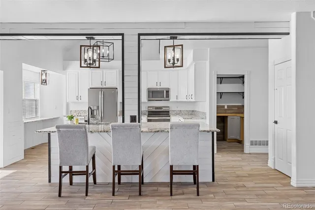 a kitchen with stainless steel appliances a refrigerator and microwave