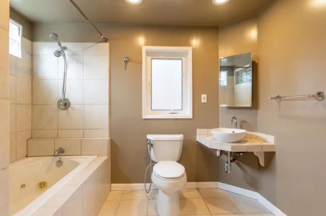 a bathroom with a sink toilet and shower