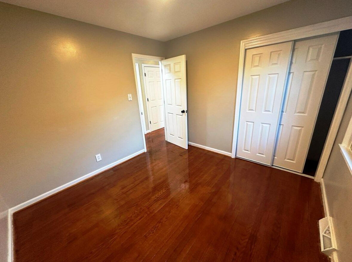 303 Swain Drive Danville, VA 24540 - Photo 15 of 24 an empty room with wooden floor and windows