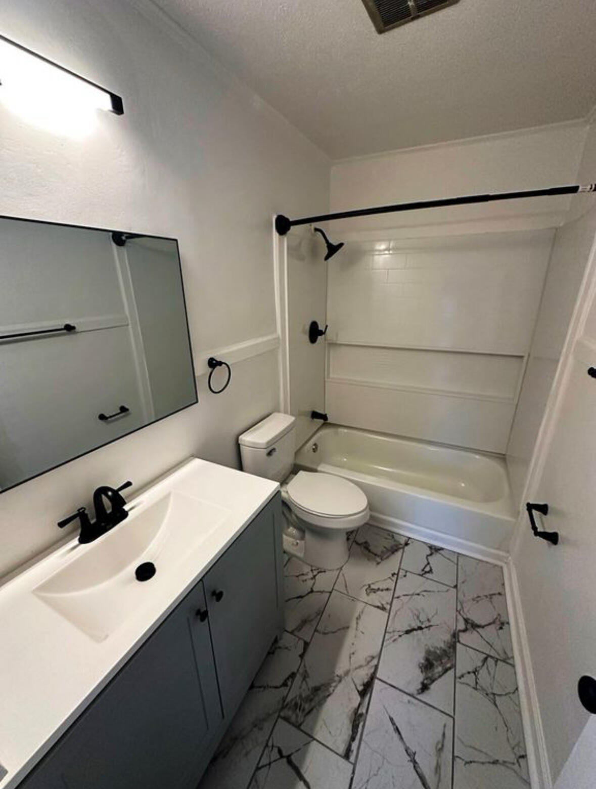 303 Swain Drive Danville, VA 24540 - Photo 16 of 24 a bathroom with a sink mirror and toilet