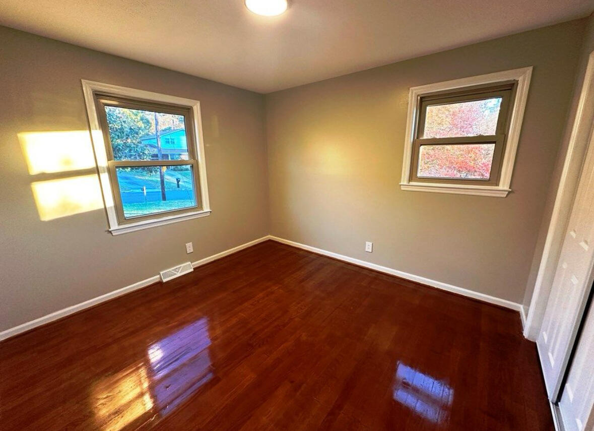 303 Swain Drive Danville, VA 24540 - Photo 17 of 24 a view of an empty room with wooden floor and a window
