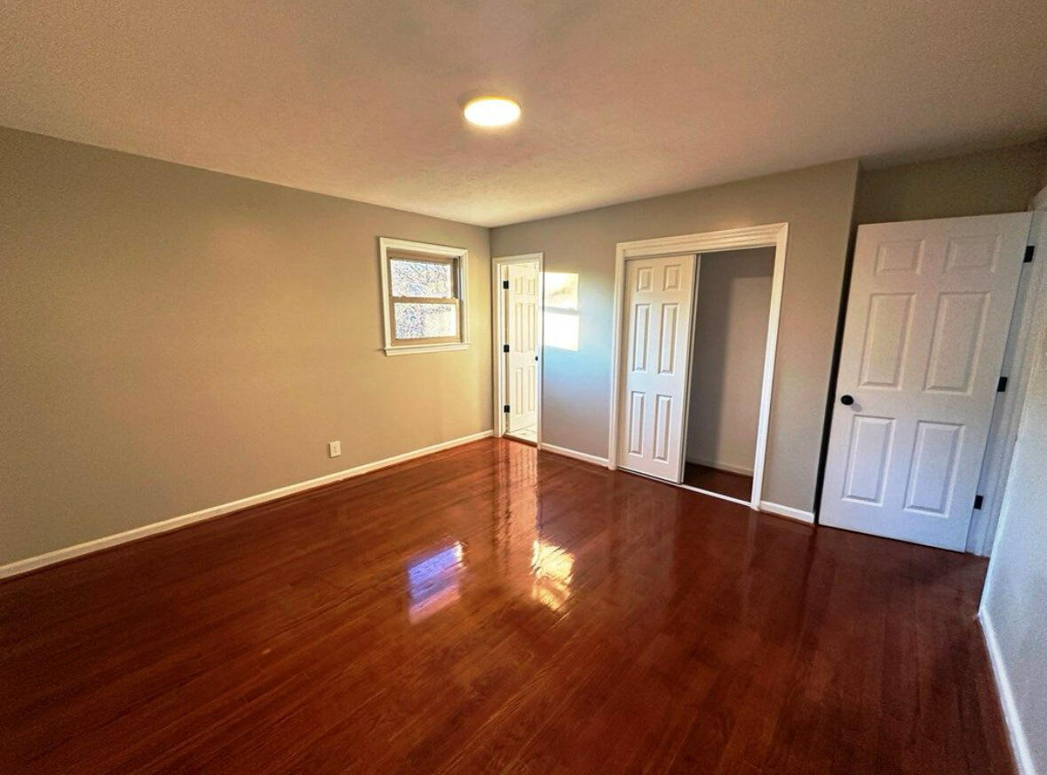 303 Swain Drive Danville, VA 24540 - Photo 18 of 24 a view of an empty room with wooden floor and a window