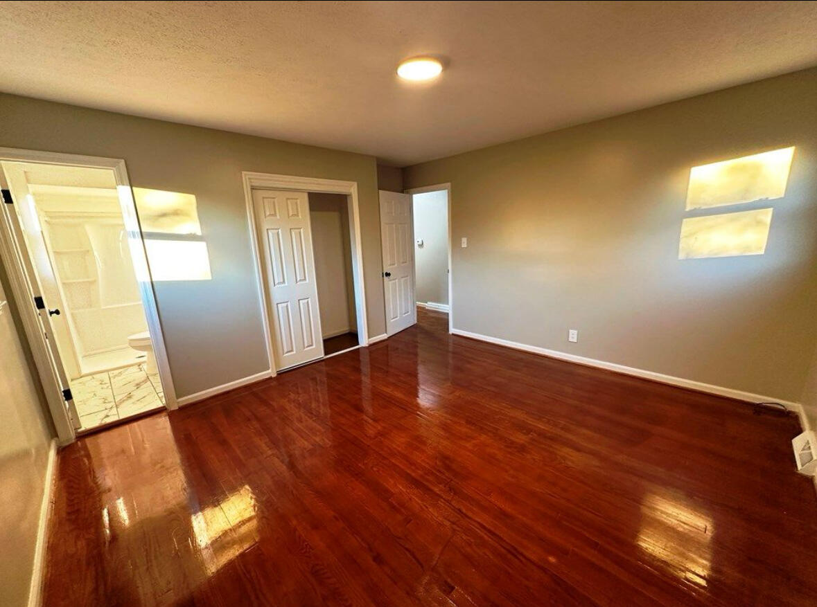 303 Swain Drive Danville, VA 24540 - Photo 19 of 24 an empty room with wooden floor and windows