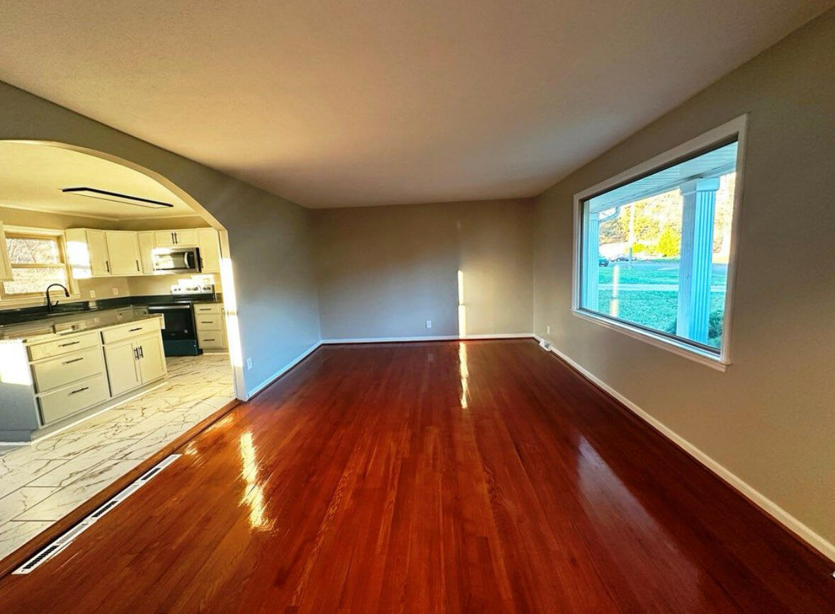 303 Swain Drive Danville, VA 24540 - Photo 3 of 24 wooden floor in an empty room with a window