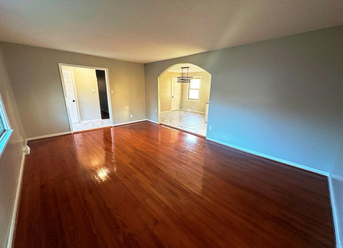 303 Swain Drive Danville, VA 24540 - Photo 5 of 24 a view of empty room with wooden floor and fan