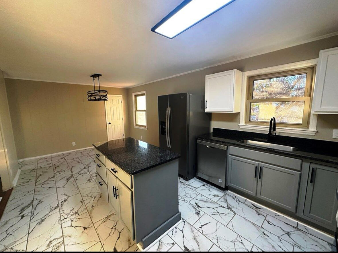 303 Swain Drive Danville, VA 24540 - Photo 10 of 24 a kitchen with a sink a counter top space and stainless steel appliances