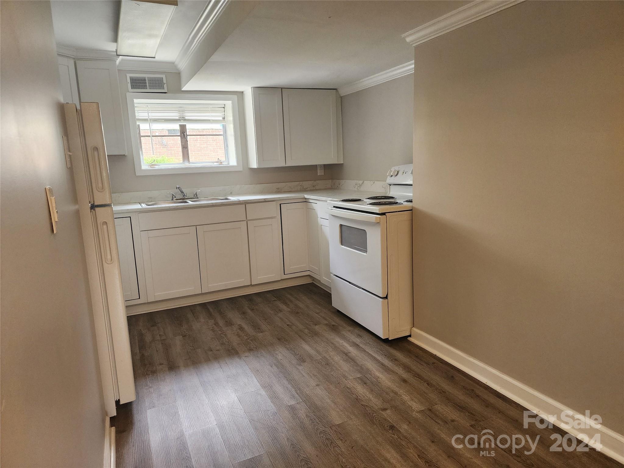 474 Hope Street Rock Hill, SC 29730 - Photo 17 of 18 a kitchen with granite countertop white cabinets and white appliances