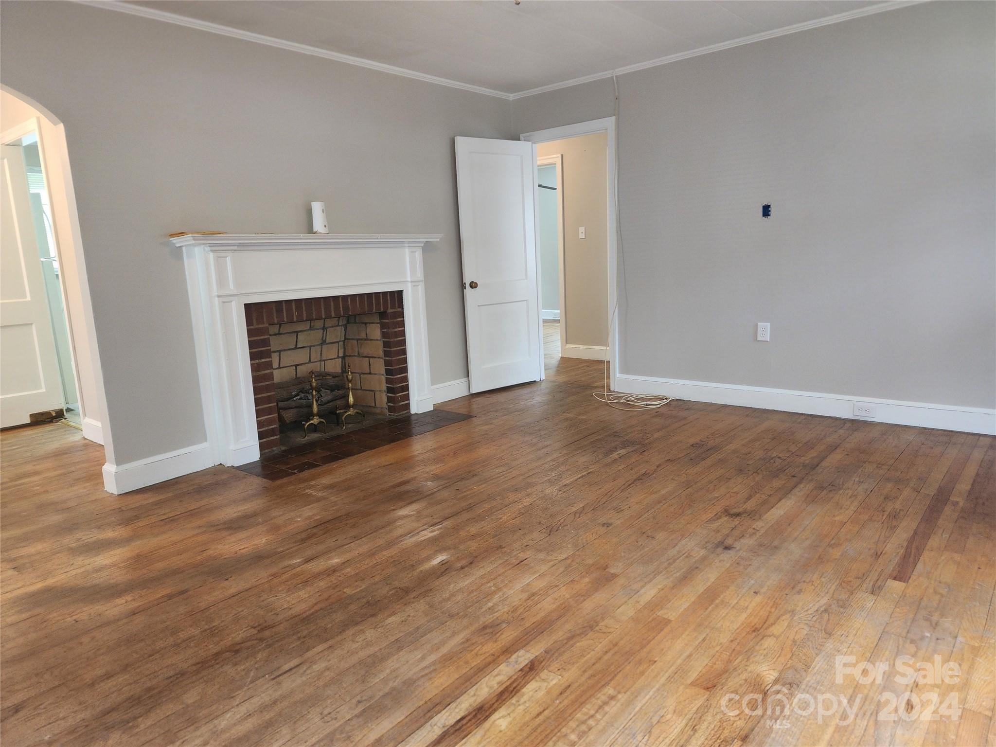 474 Hope Street Rock Hill, SC 29730 - Photo 5 of 18 a view of an empty room with wooden floor and a fireplace