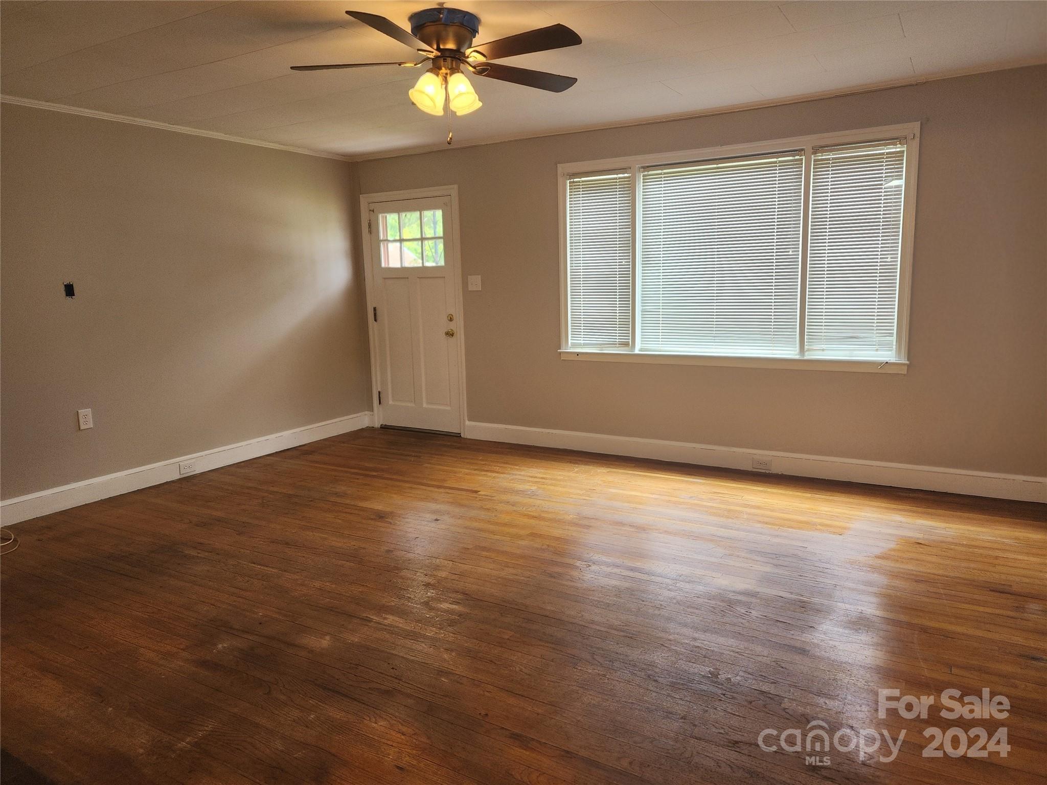 474 Hope Street Rock Hill, SC 29730 - Photo 6 of 18 an empty room with wooden floor fan and windows