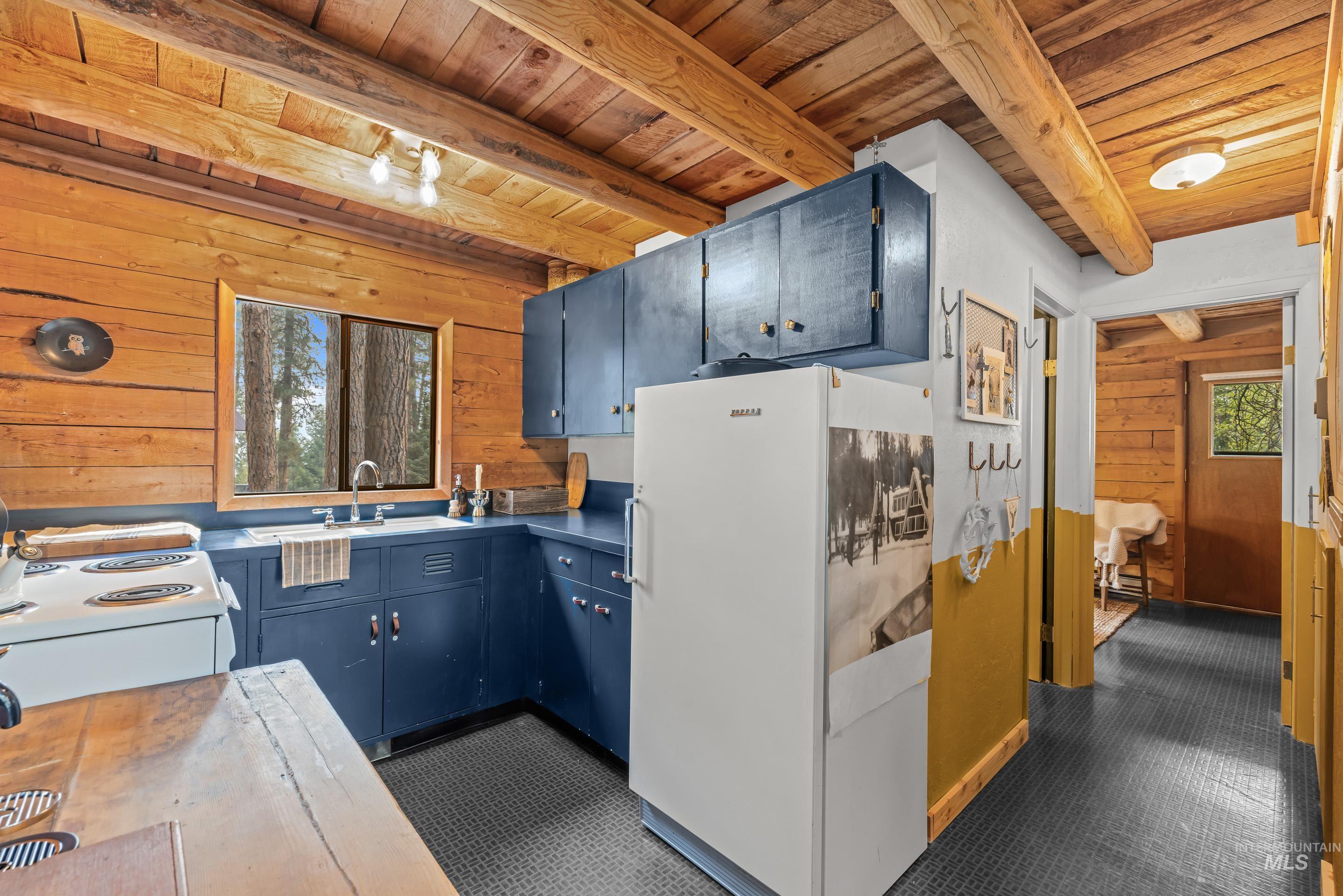 73 Rainbow Ridge Road Garden Valley, ID 83622 - Photo 8 of 49 Wood-paneled walls and ceiling with exposed wood beams