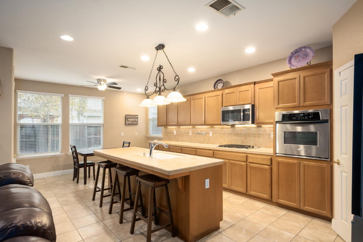 775 South Michelle Avenue Kerman, CA 93630 - Photo 12 of 37 a kitchen with a sink and stove