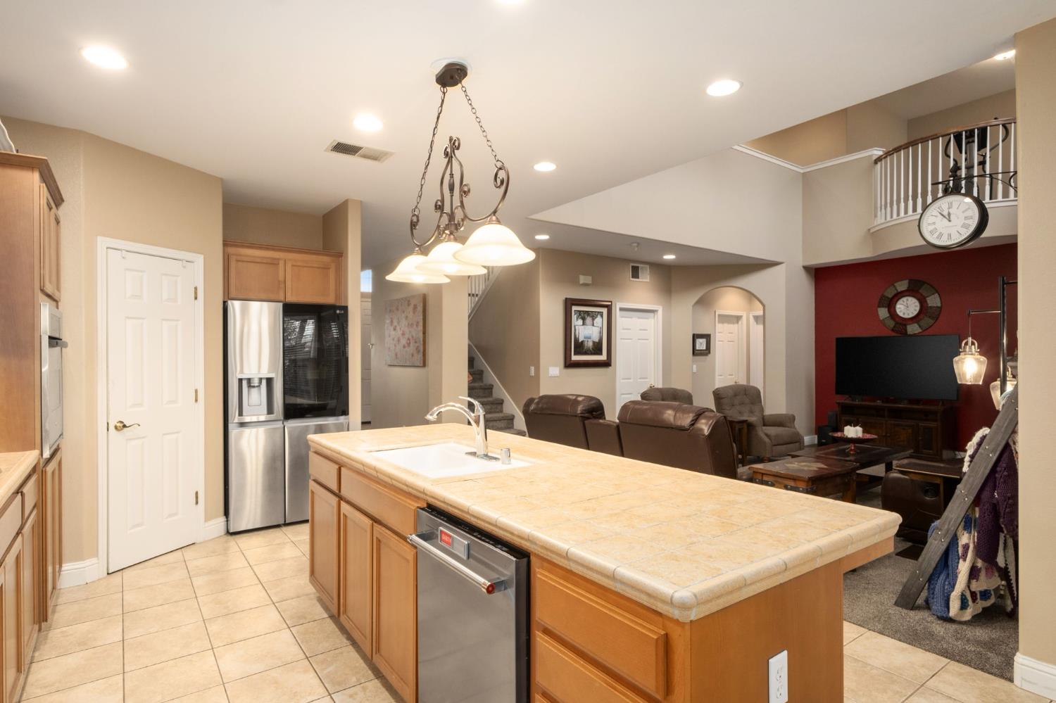 775 South Michelle Avenue Kerman, CA 93630 - Photo 16 of 37 a room with kitchen island a sink and a refrigerator