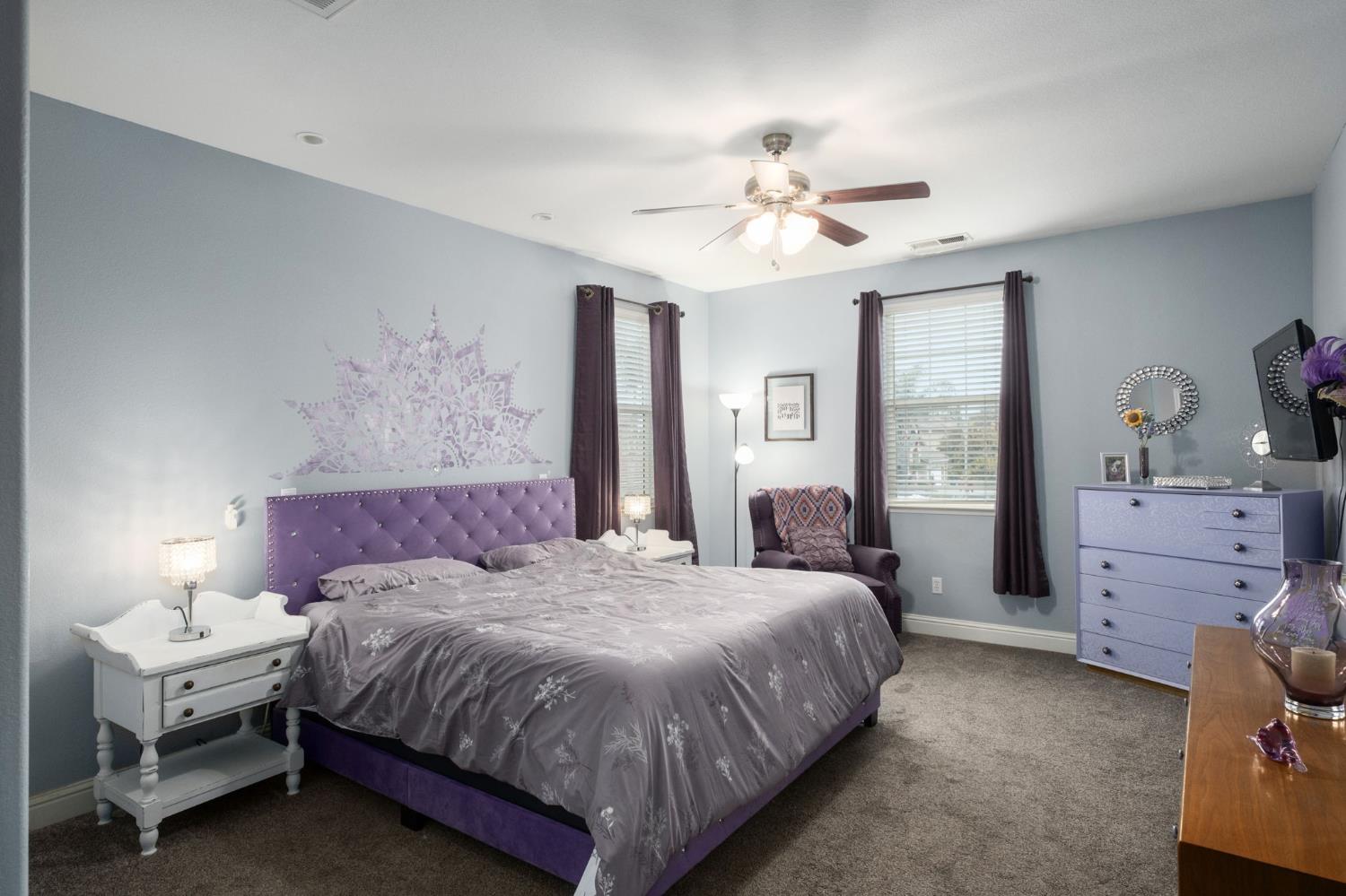 775 South Michelle Avenue Kerman, CA 93630 - Photo 25 of 37 a spacious bedroom with a bed and a chandelier