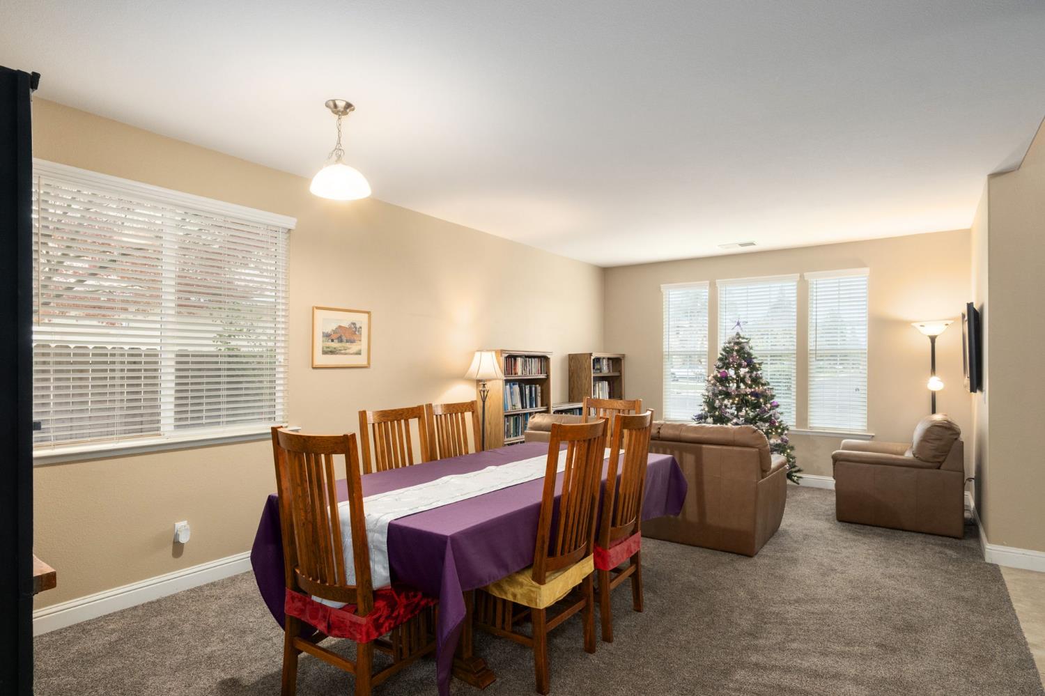 775 South Michelle Avenue Kerman, CA 93630 - Photo 7 of 37 a living room with furniture a flat screen tv and a large window
