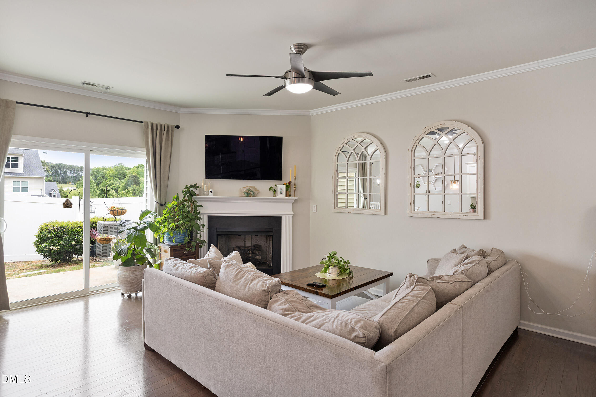 108 Zante Currant Road Durham, NC 27703 - Photo 11 of 33 a living room with furniture a fireplace and a flat screen tv