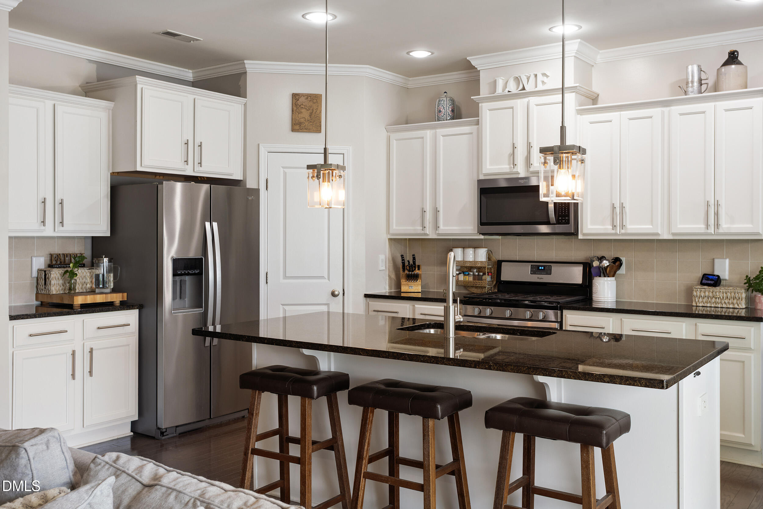 108 Zante Currant Road Durham, NC 27703 - Photo 14 of 33 a kitchen with stainless steel appliances a refrigerator a stove a sink and white cabinets