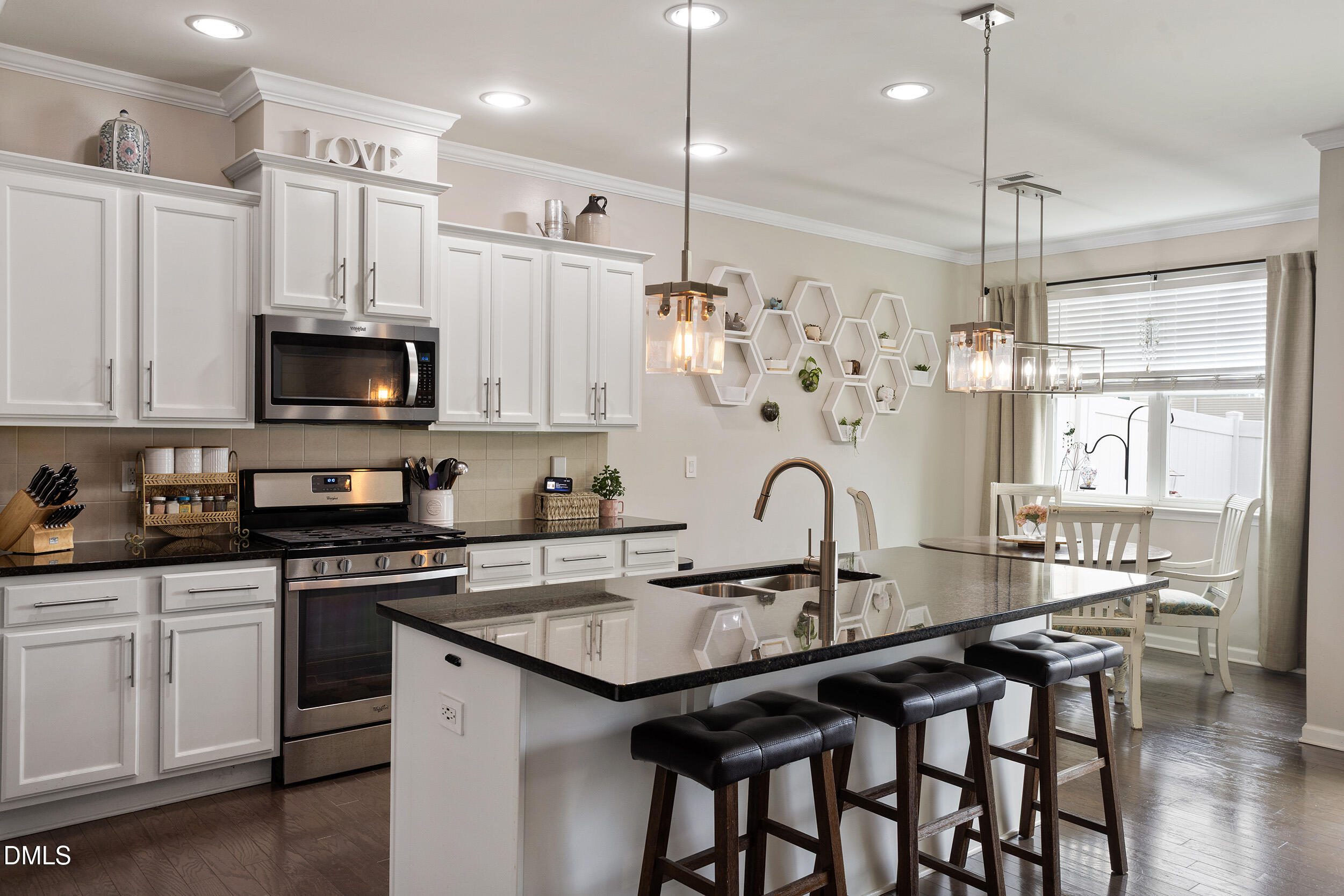108 Zante Currant Road Durham, NC 27703 - Photo 15 of 33 a kitchen with granite countertop a sink a center island a stove and cabinets