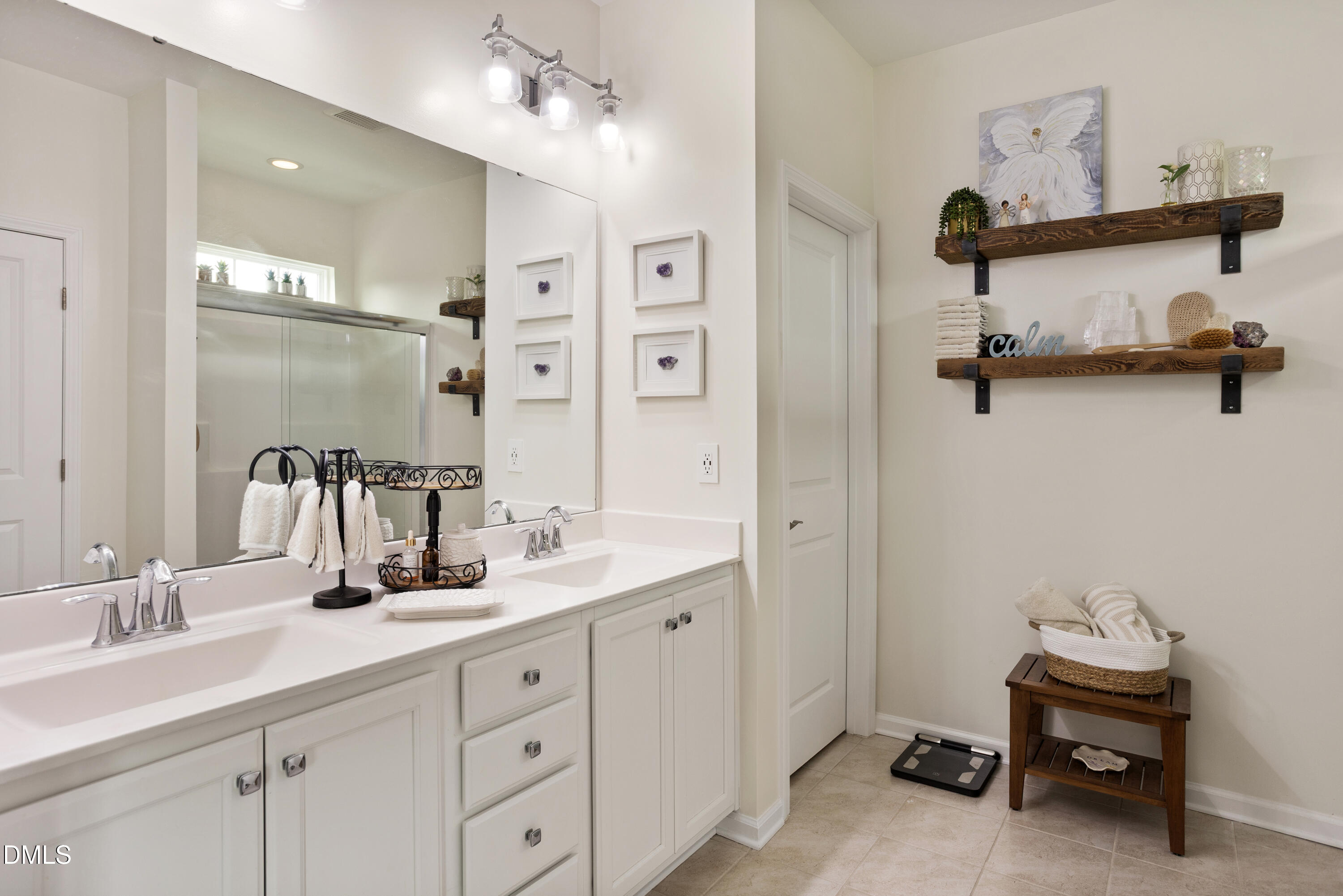 108 Zante Currant Road Durham, NC 27703 - Photo 25 of 33 a bathroom with a double vanity sink a mirror and shower