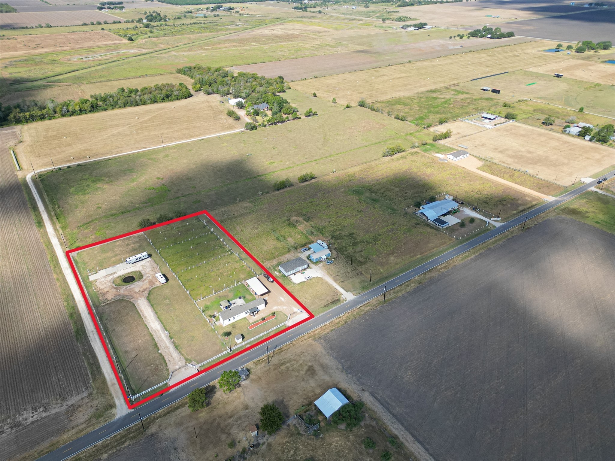 Aerial view outlining the property boundaries with open pastureland and a peaceful rural setting.