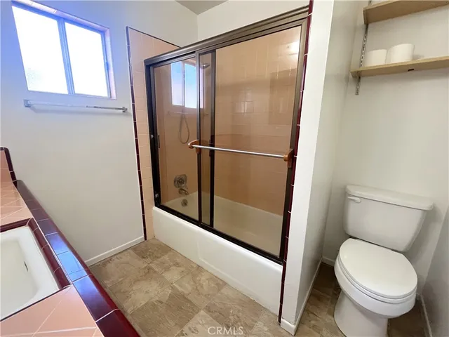 a bathroom with a tub and a shower