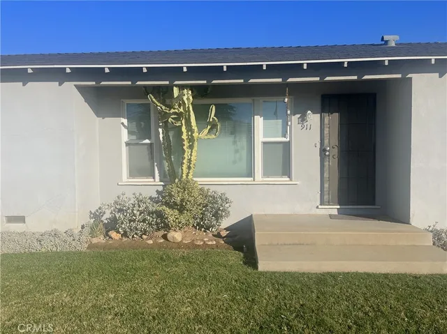 a front view of a house with garden