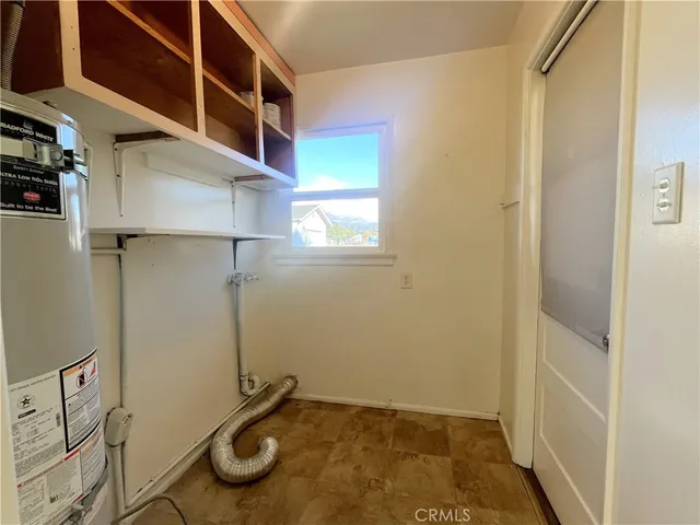 a view of a hallway with bathroom and wooden floor