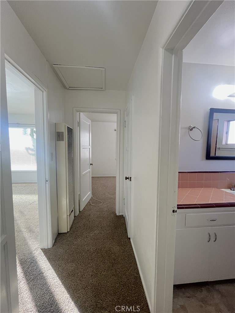 911 Park Avenue Calimesa, CA 92320 - Photo 10 of 19 a view of a hallway with bathroom and wooden floor